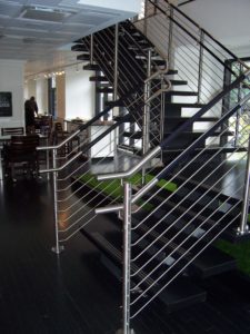 Circum Round balustrade with wood top rail and stainless steel infill rails