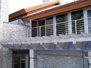 Circum Round balustrade with ipe wood top rail and stainless steel infill rails